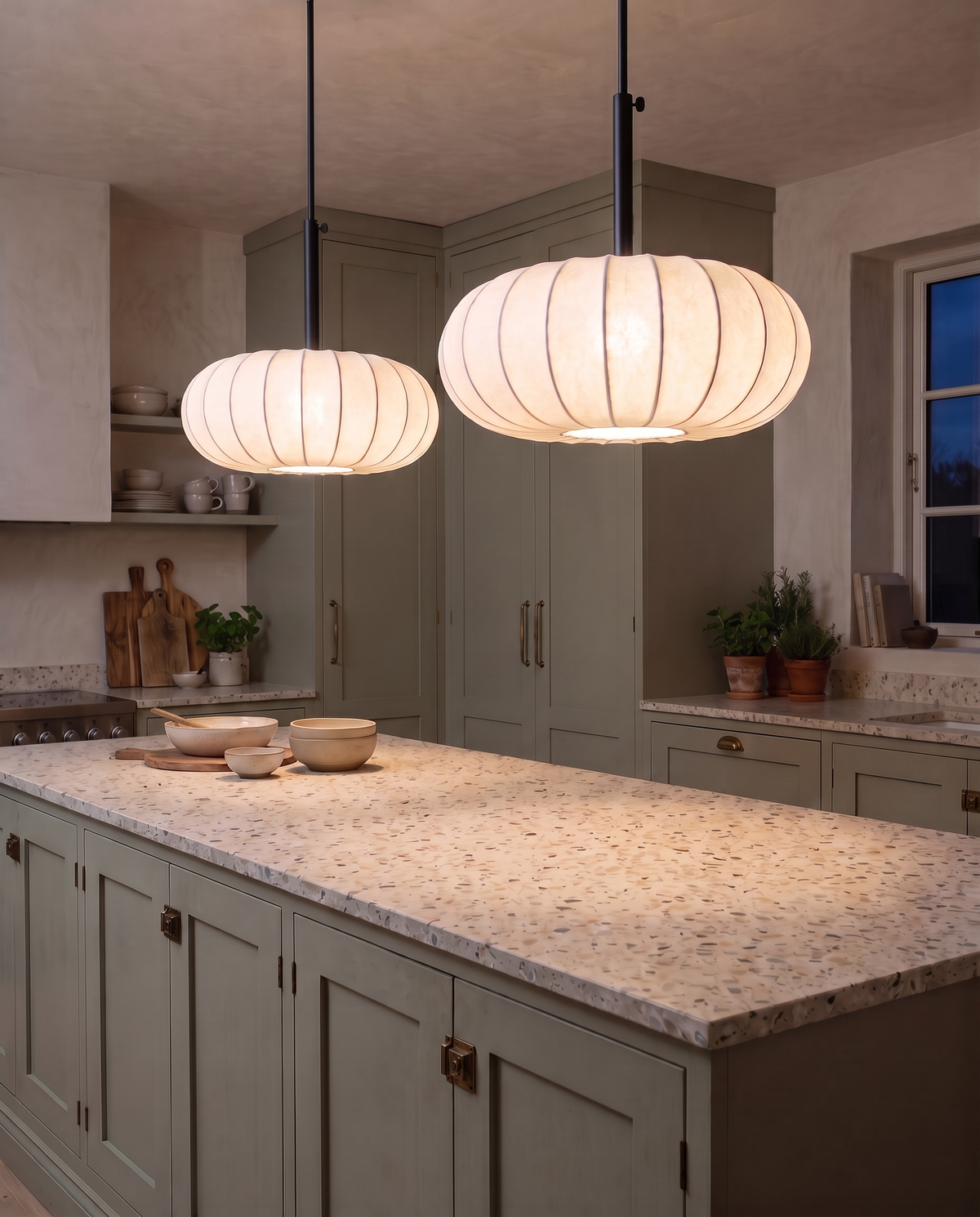 Two Veil pendants in a line over a terrazzo kitchen island