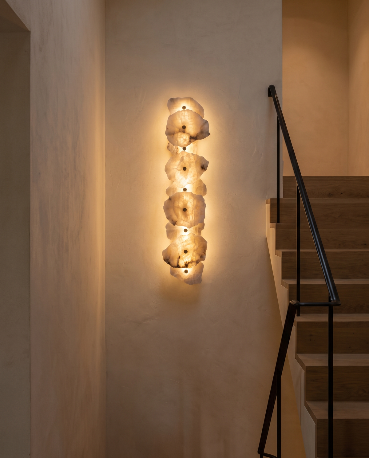 The Strata Wall Light with nine heads on a stairwell wall
