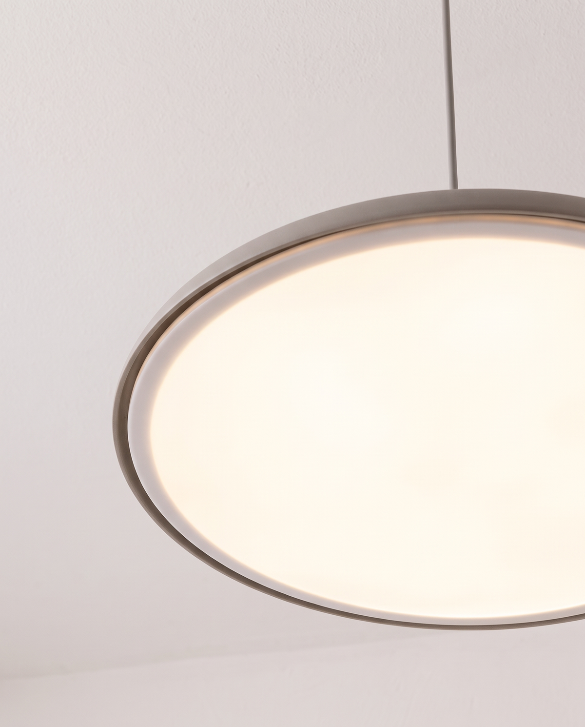The Wafer Pendant's lit diffuser seen from below