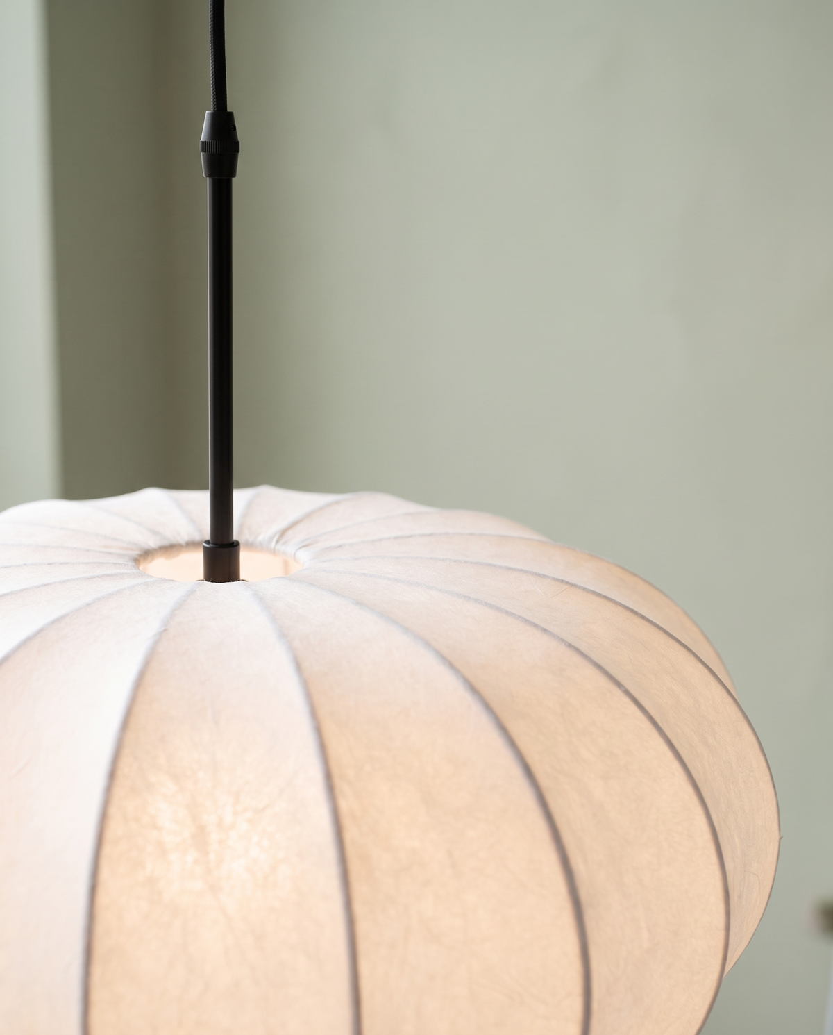 Close-up of The Veil's black stem meeting the top of the fabric shade