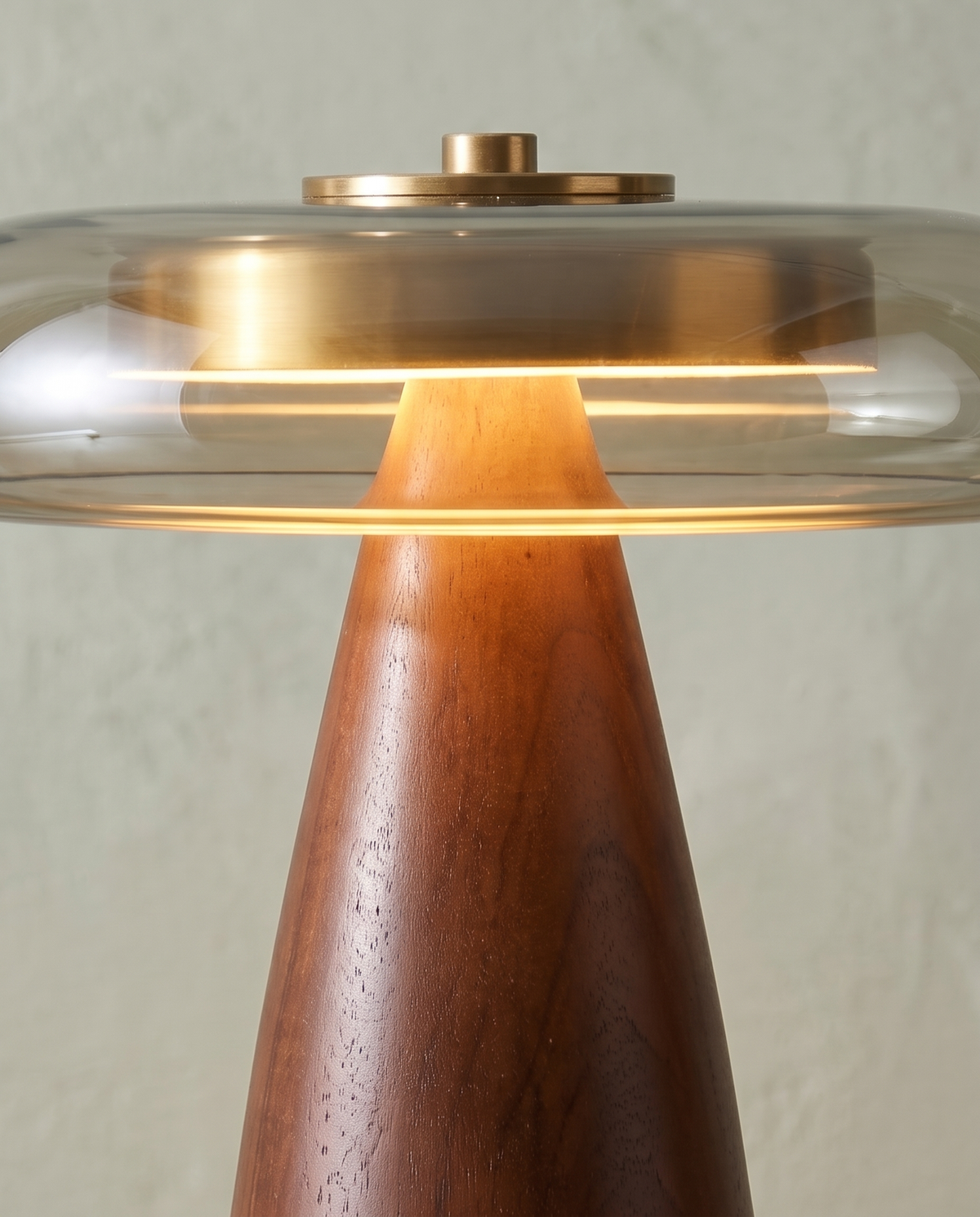 The Dovetail walnut table lamp – Close-up of the smoky glass shade with the brass disc inside