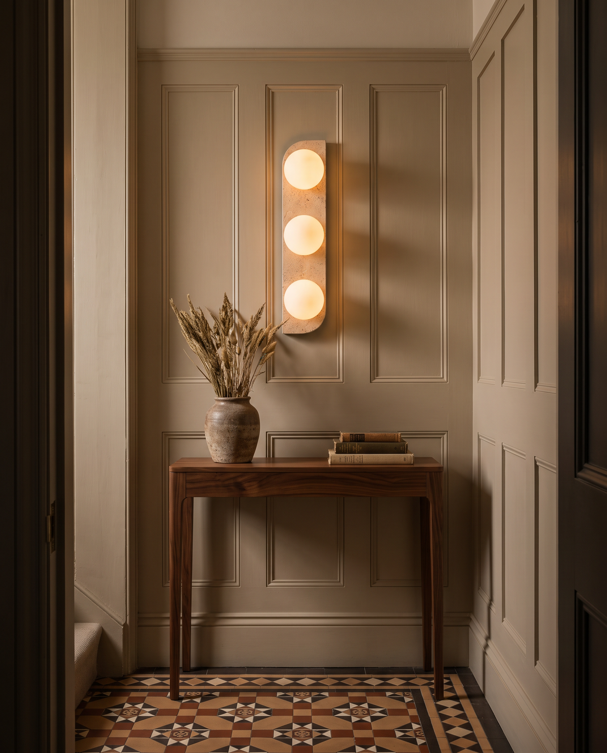 The Abacus triple wall light in travertine above a walnut console in a Georgian hallway