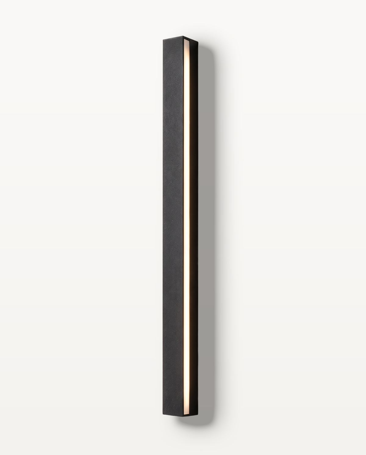 The Beacon outdoor wall light, a black linear LED bar on a limewashed wall