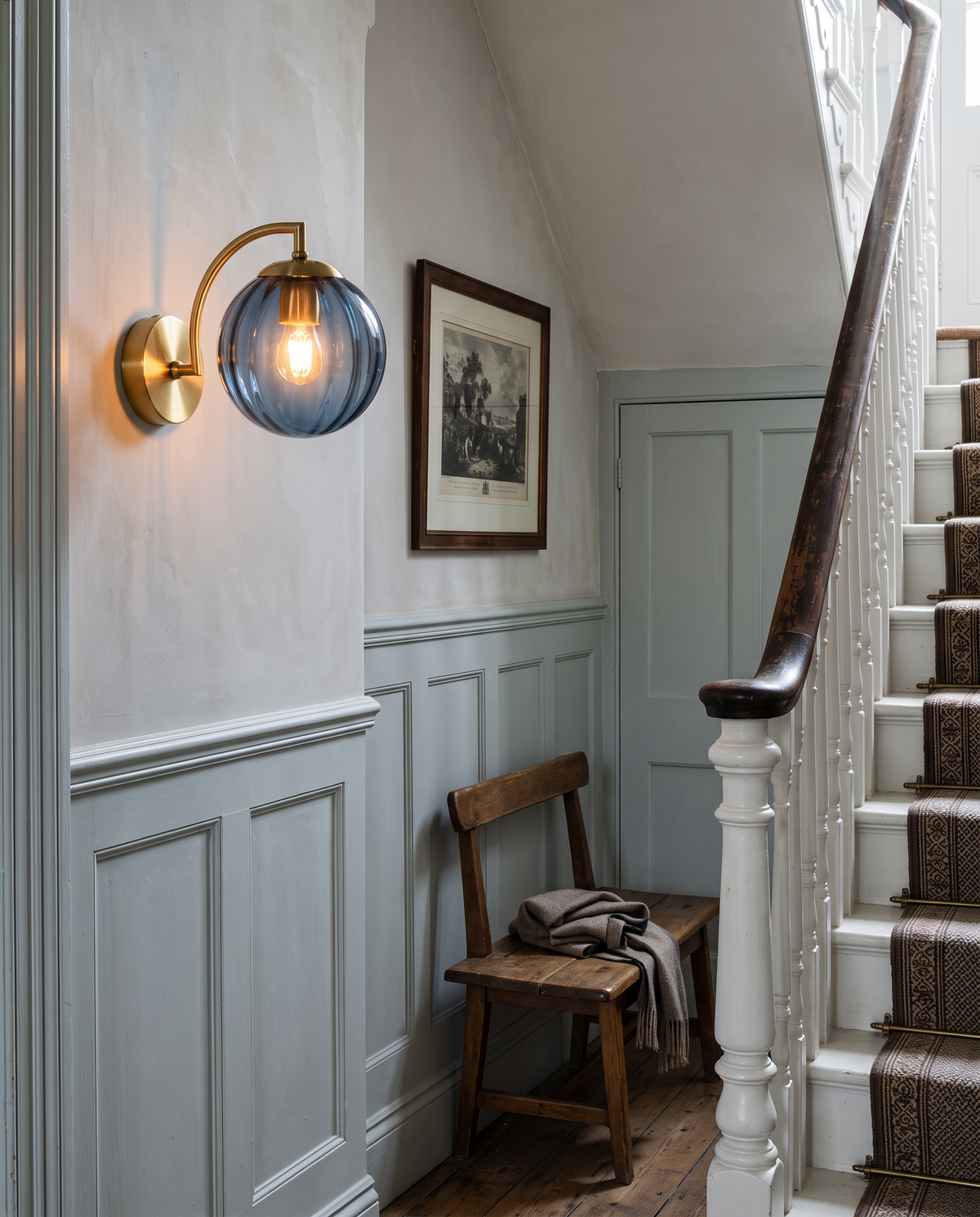 The Bloom wall sconce in blue ribbed glass in an Edwardian hallway by the stairs