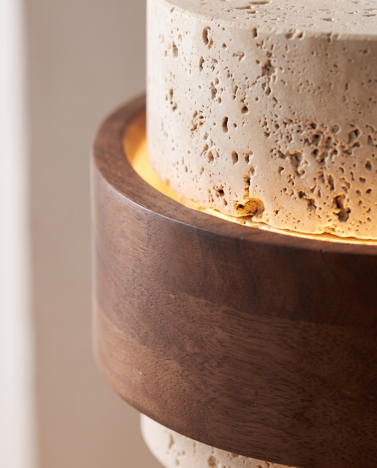 Close-up of the wooden band meeting the travertine on The Bobbin