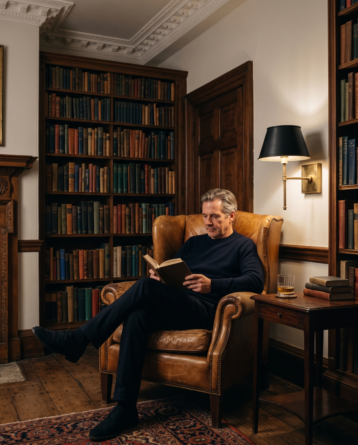 A man reading in a leather wing chair under The Bureau