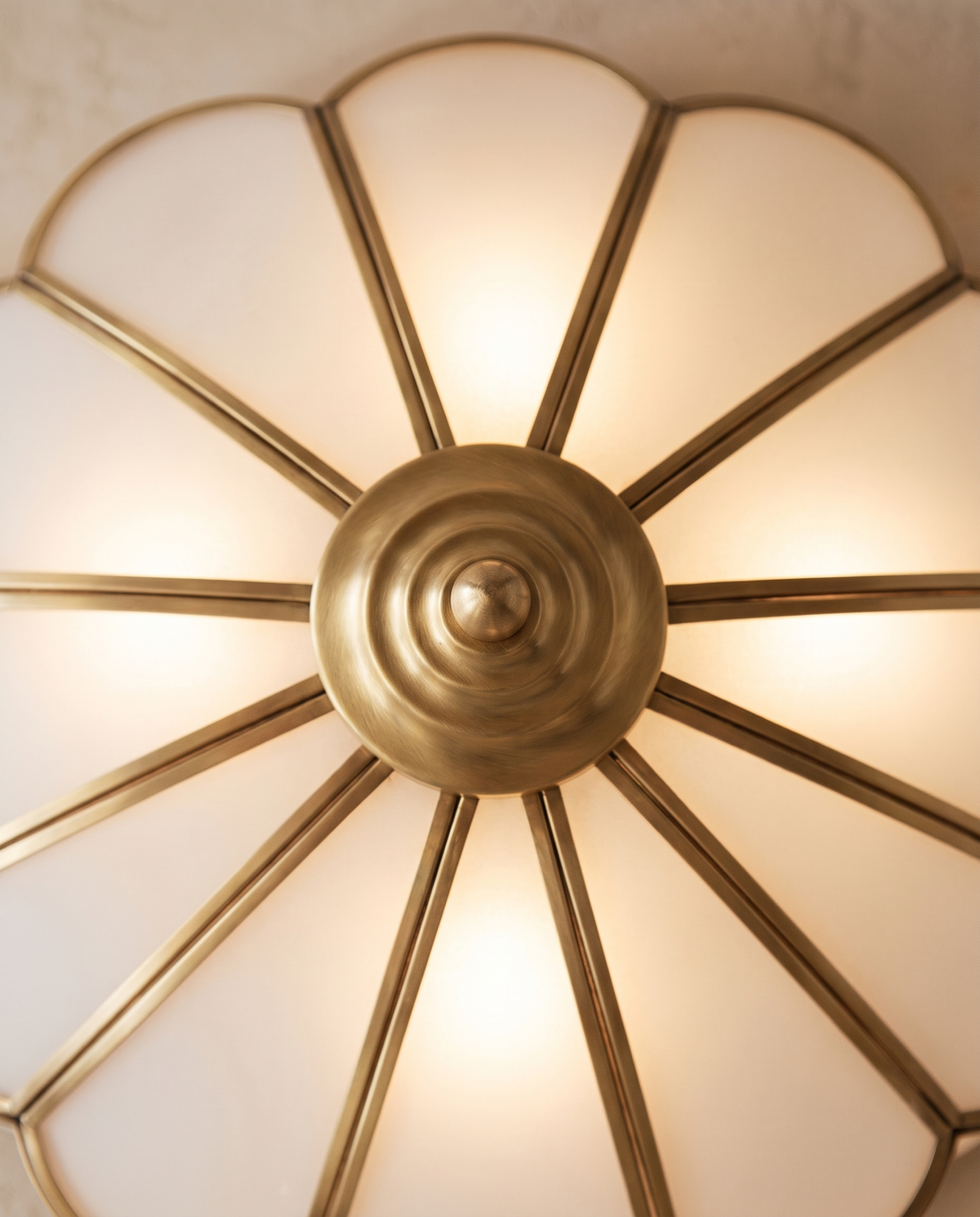 Close-up of the brass-finish boss and petal frames of The Camellia