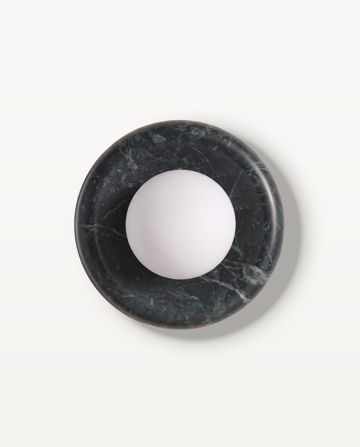 The Cameo Wall Light in Slate Green – a ring of dark slate green marble with a frosted glass globe, seen from the front