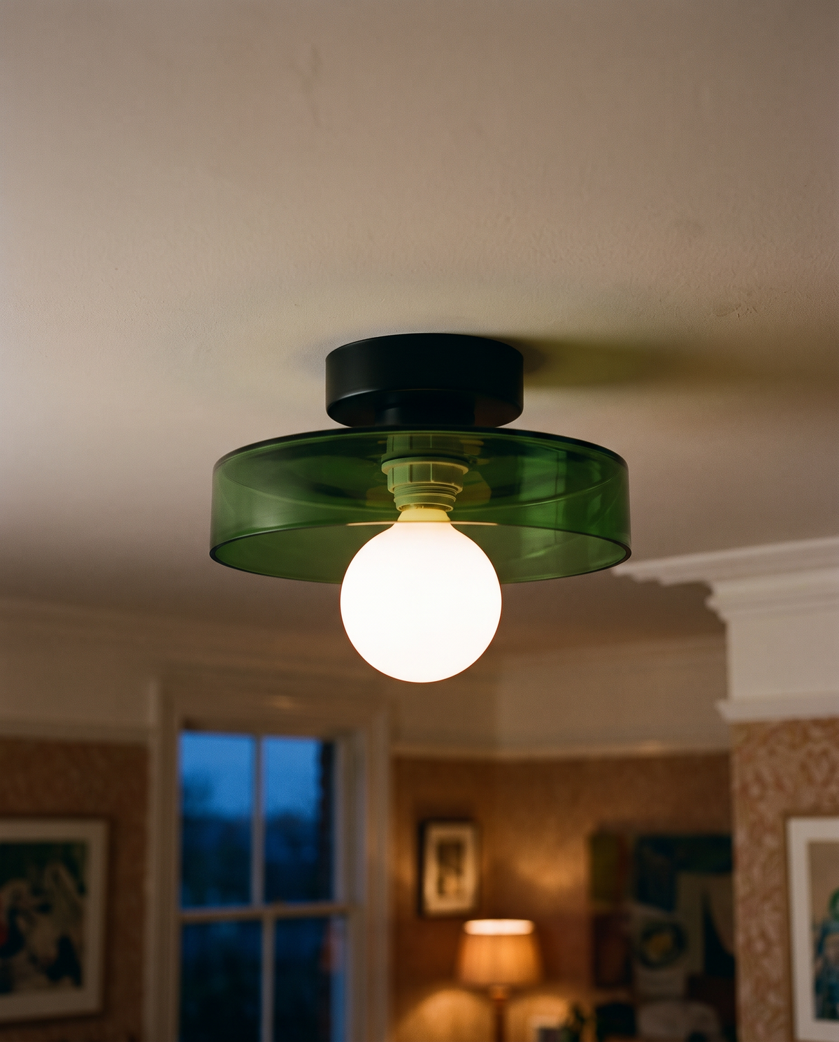 Close-up of the bottle green glass shade and opal globe of The Cloche