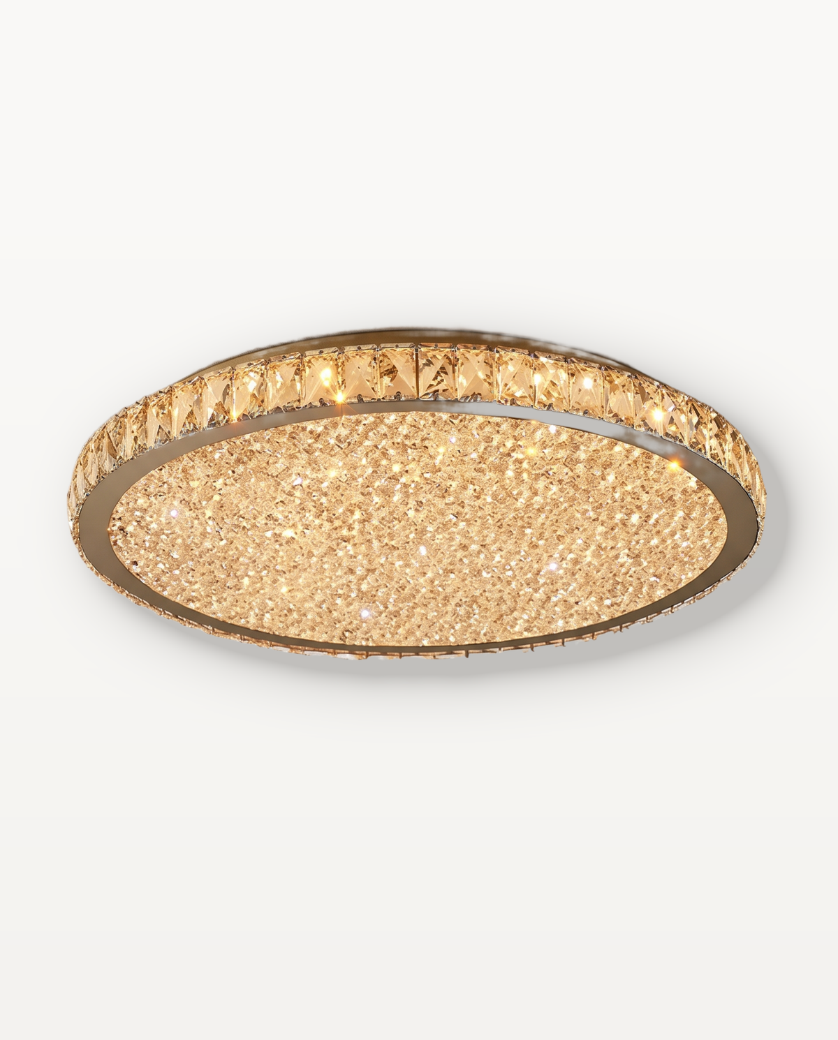 The Coronet Ceiling Light in Champagne, a ring of faceted amber crystal with a gold rim, lit