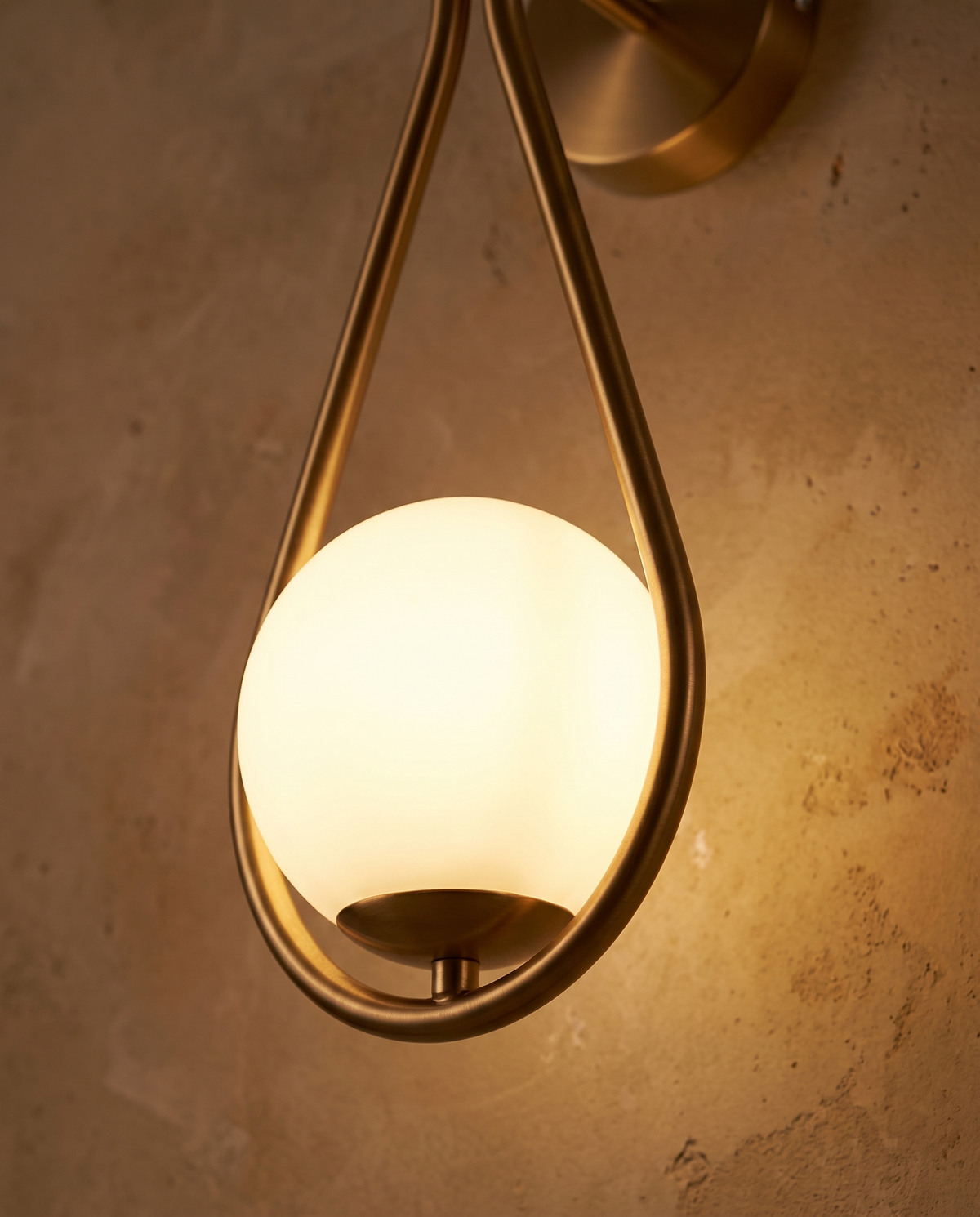 The gold teardrop frame and glowing opal globe of The Droplet
