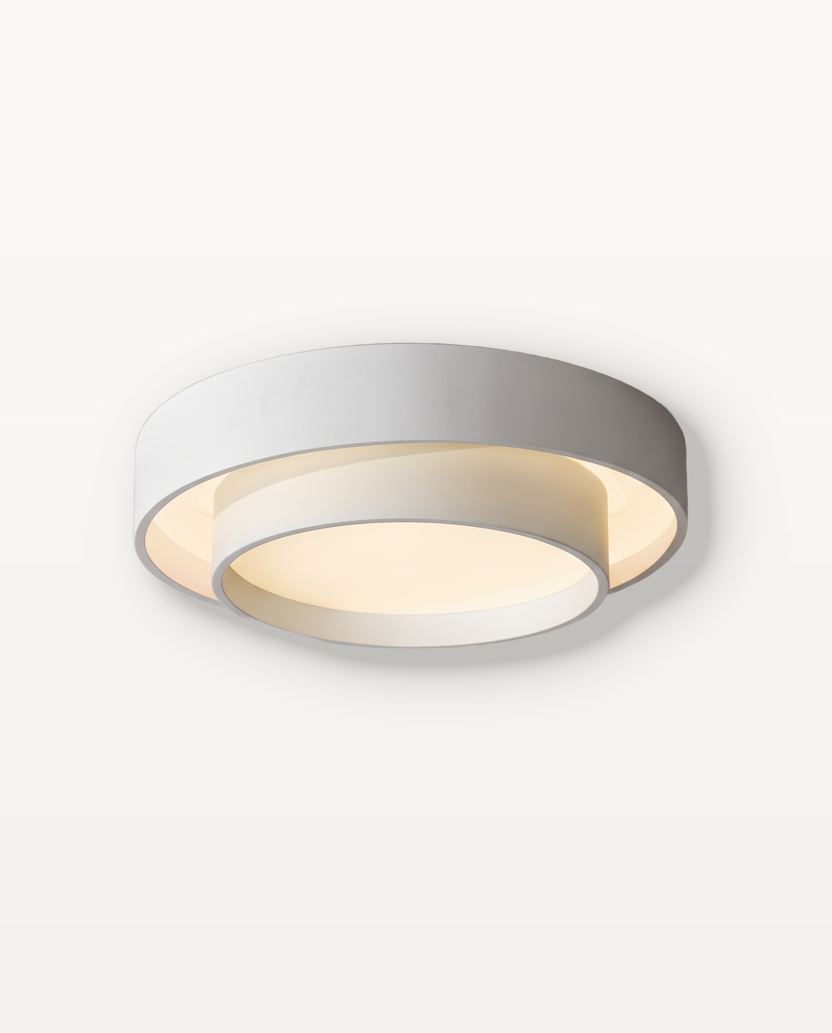 The Echo Ceiling Light in Chalk, a flush drum with an offset inner ring, lit
