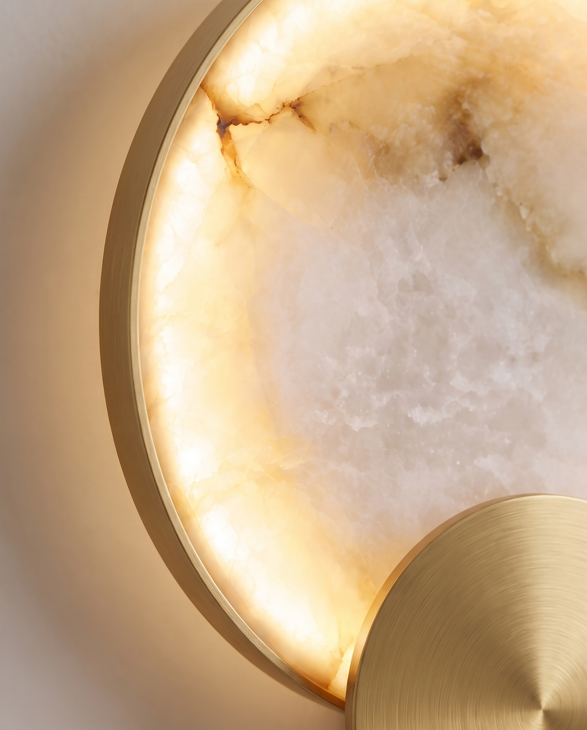 Close-up of the Eclipse: backlit stone veining and the brushed-gold disc