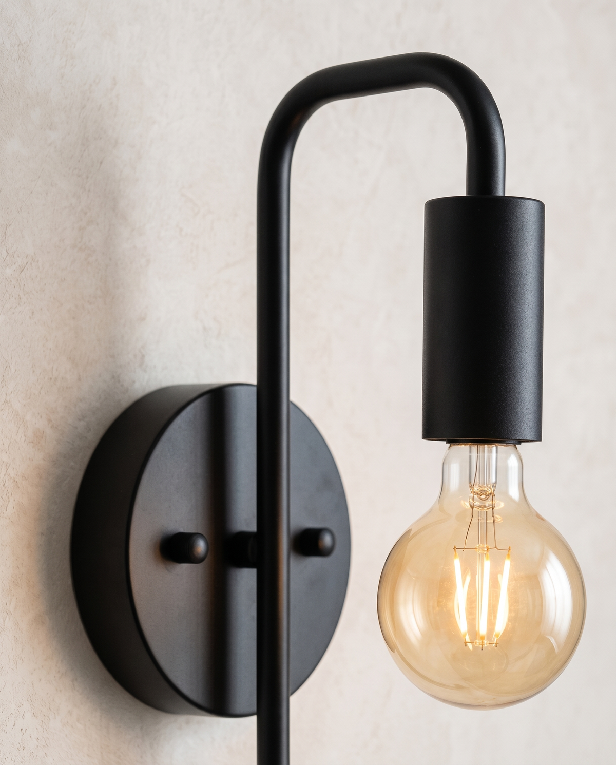 The Filament black industrial wall sconce, close-up detail of arm and bulb holder — Selden Home product photography