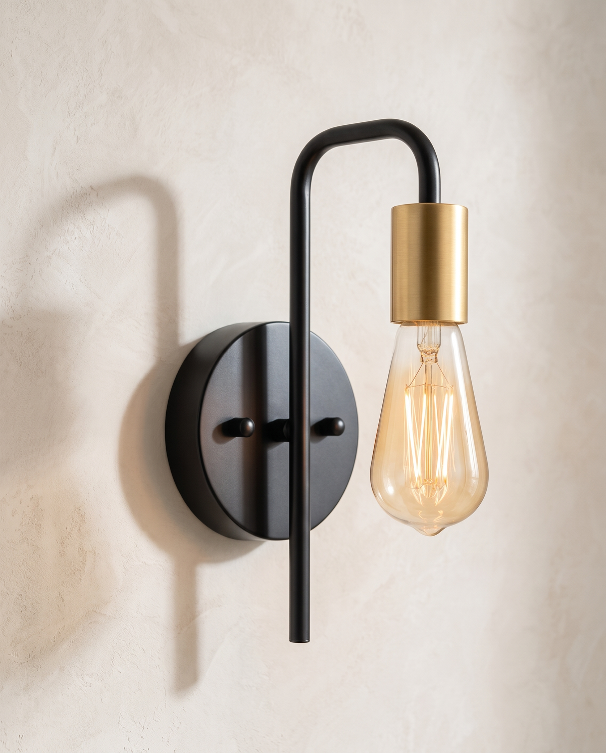 The Filament black and gold industrial wall sconce, close-up detail of arm and bulb holder — Selden Home product photography
