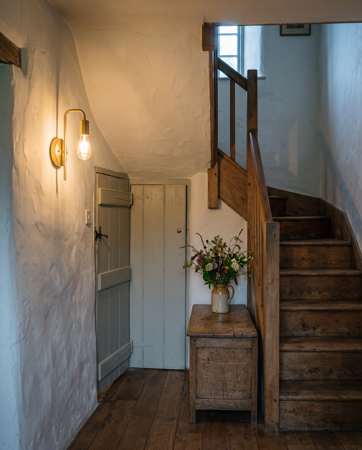 The Filament wall sconce in brass on the landing of a stone cottage