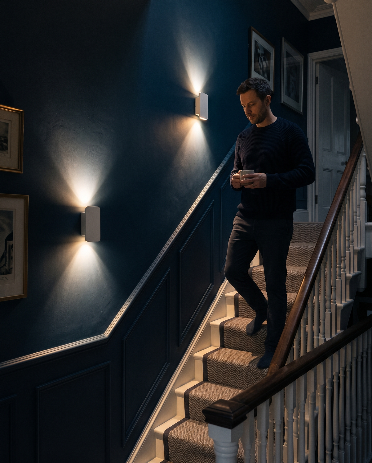 Coming down the stairs at night past Folio wall lights in Chalk