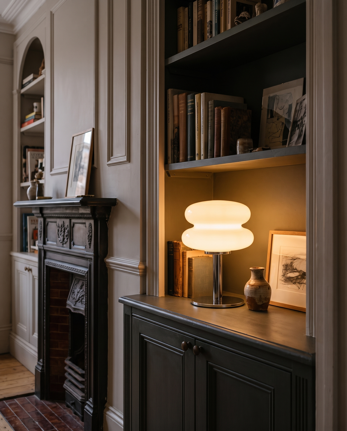 The Fondant in Meringue on an alcove bookshelf beside a fireplace