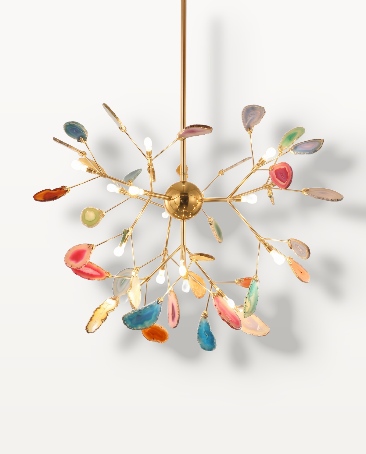 The Geode Chandelier in Harlequin, mixed agate slices on gold branches, lit