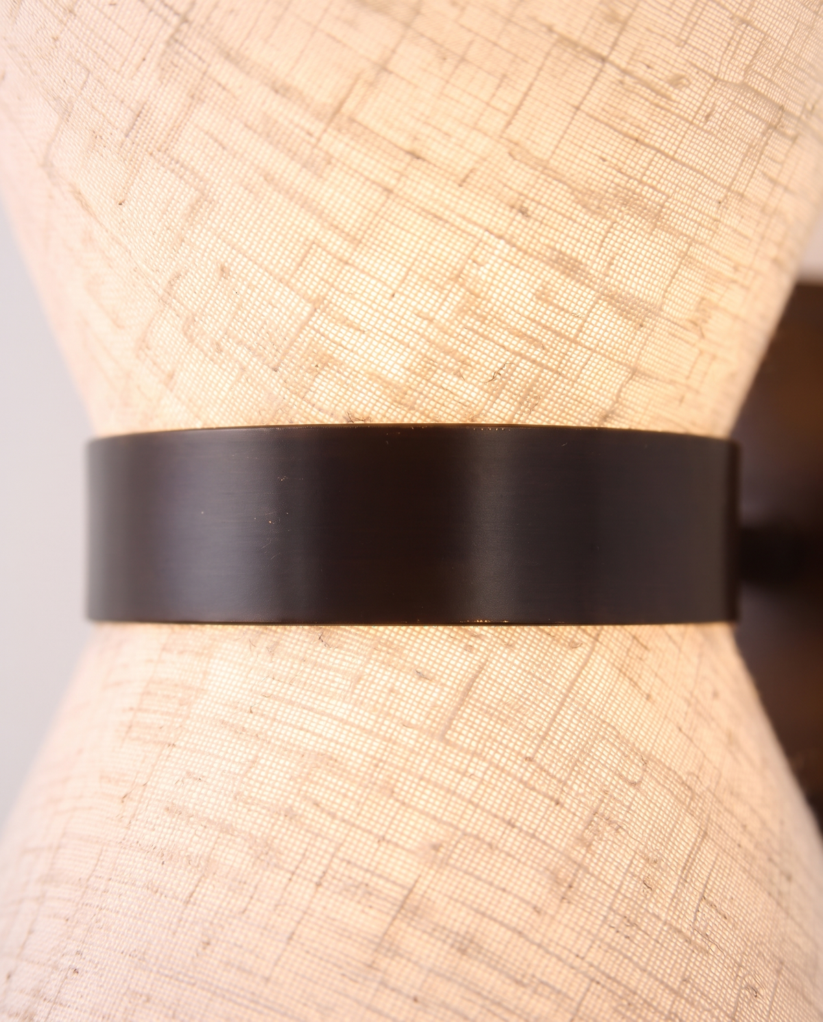 Close-up of the woven fabric and dark bronze band of The Hourglass