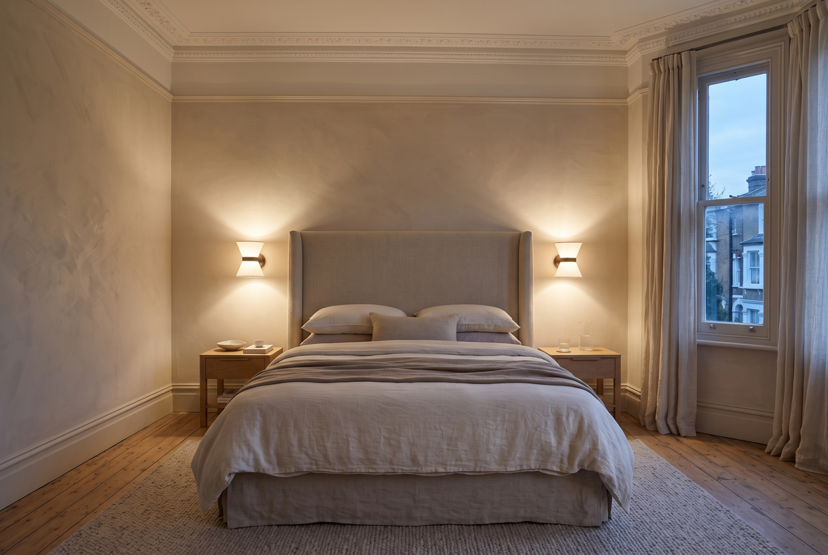 A pair of Hourglass wall lights either side of a bed