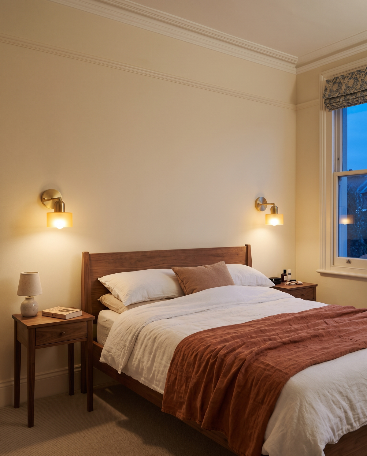A pair of Inkwell wall lights in Honey either side of a bed in a Brighton terrace