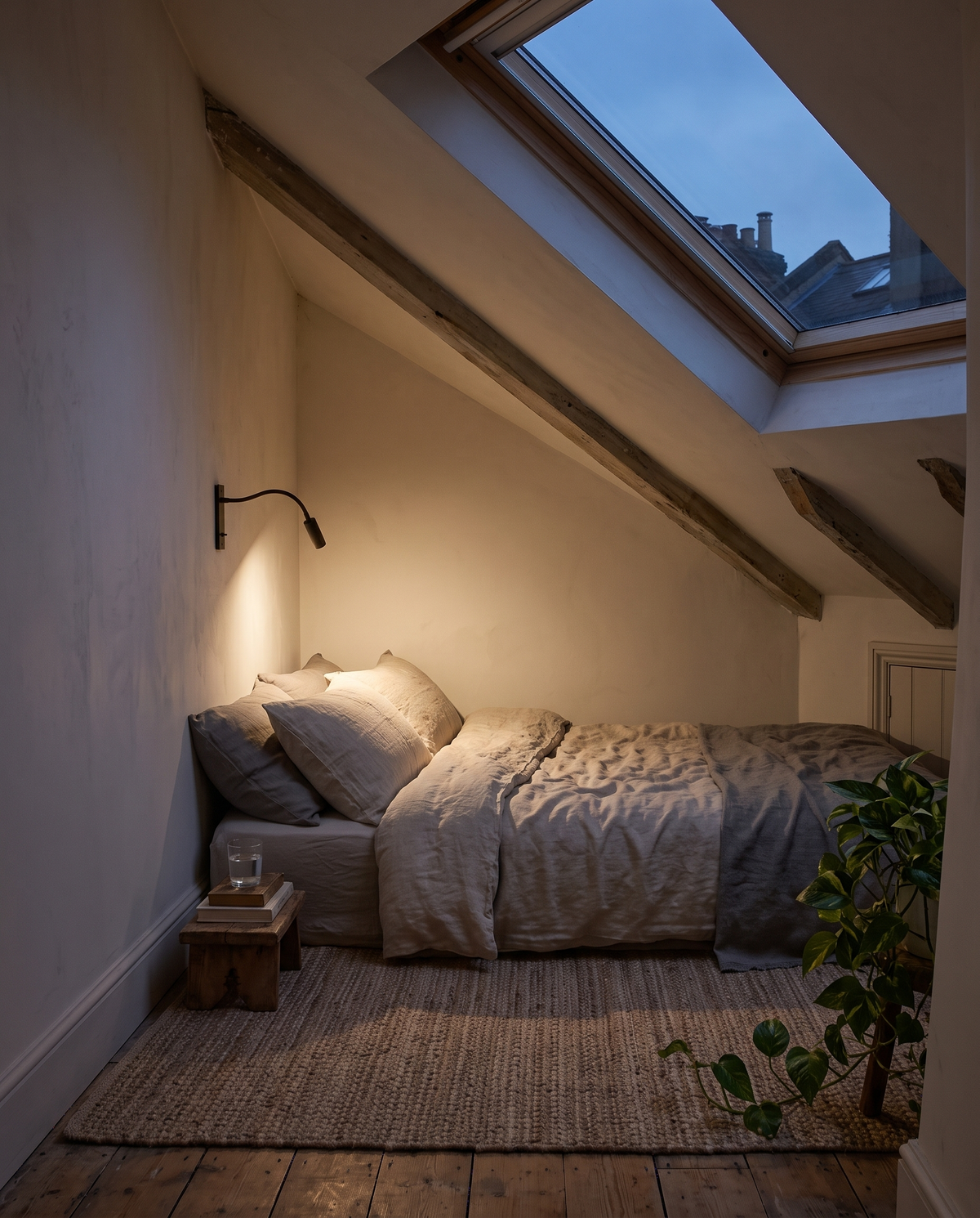 The Lectern beside a bed under a sloping loft ceiling