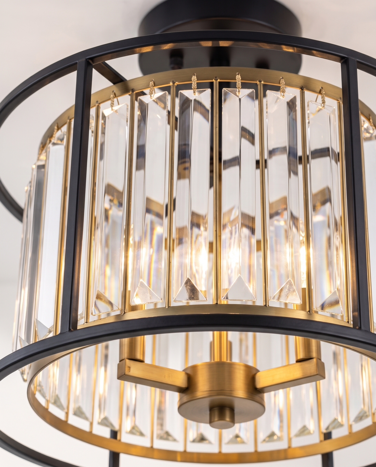Close-up of the faceted crystal prisms and brass inner frame of The Lustre