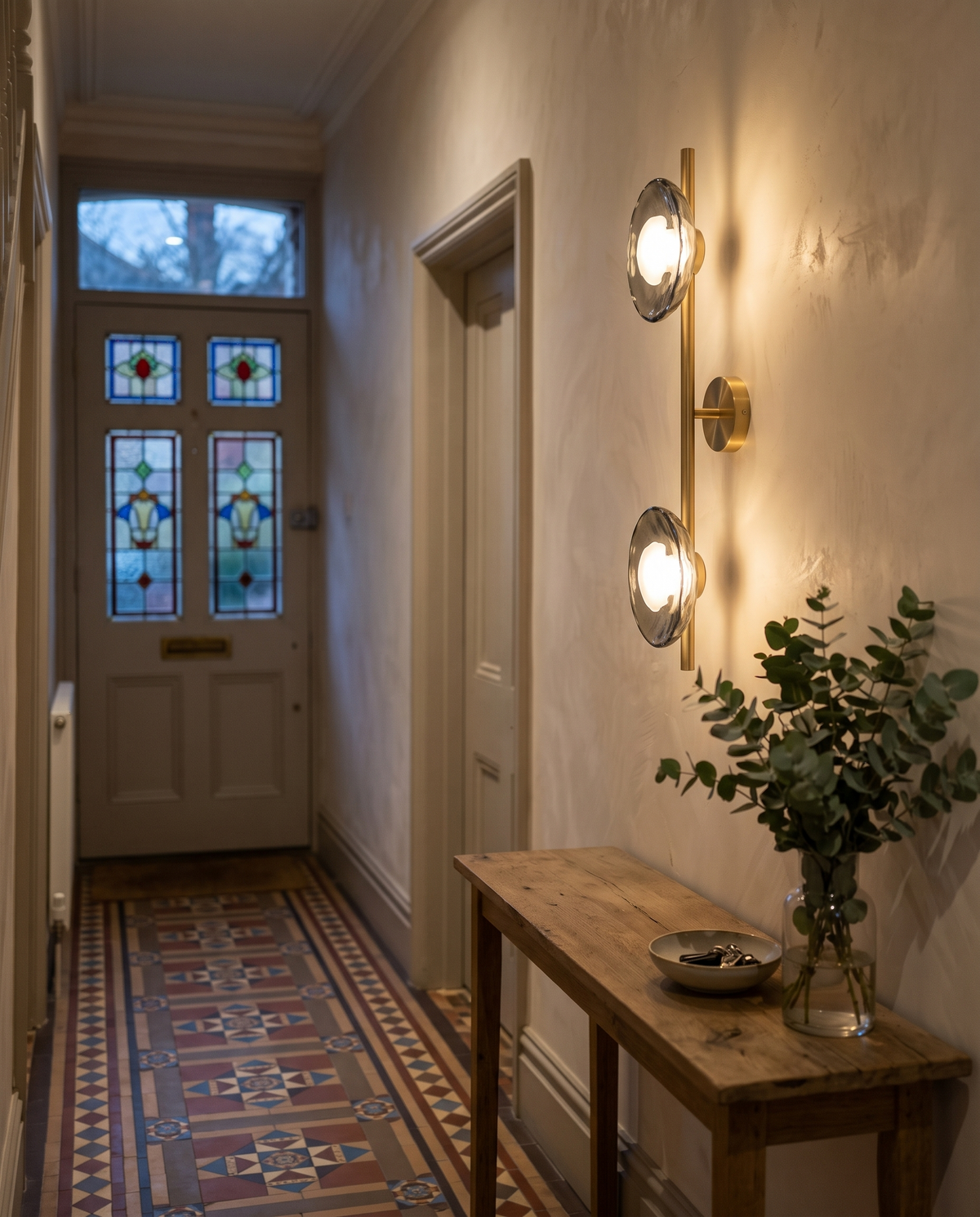 The tall Monocle above a console in a Victorian hallway
