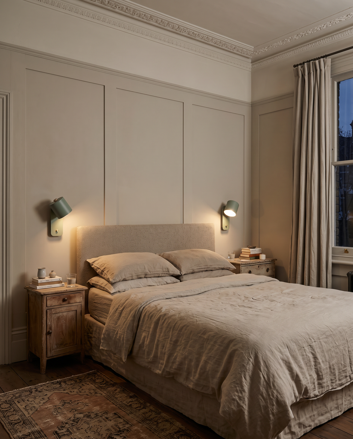 A pair of Nightcaps either side of a bed in a panelled Victorian bedroom