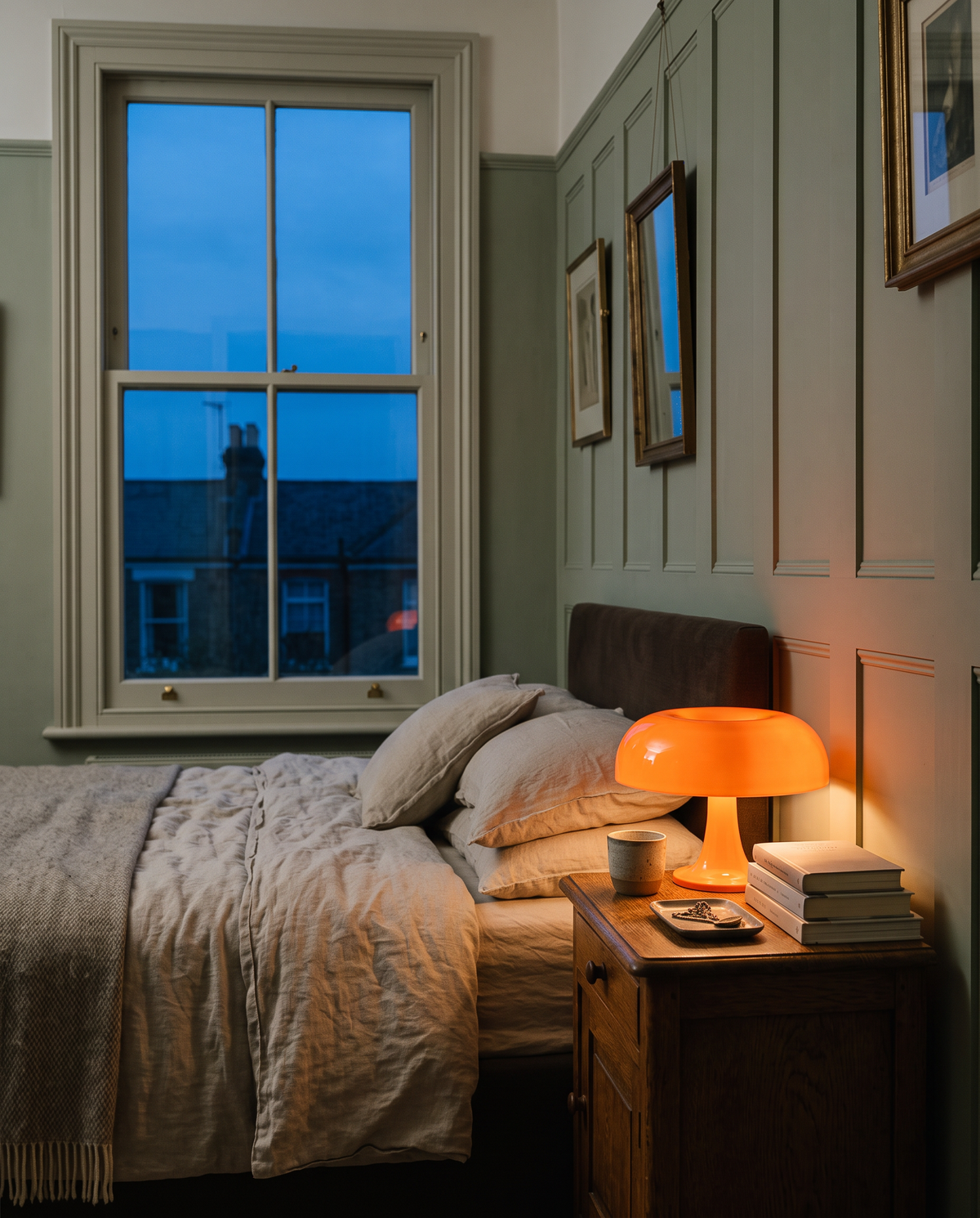 The Parasol glowing on an oak bedside table in a Victorian bedroom at dusk