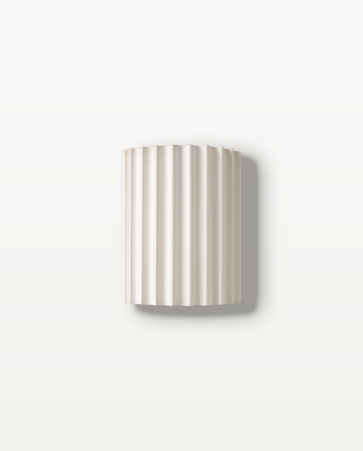 The Pleat, white fluted wall light on lime-washed plaster wall — Selden Home product photography