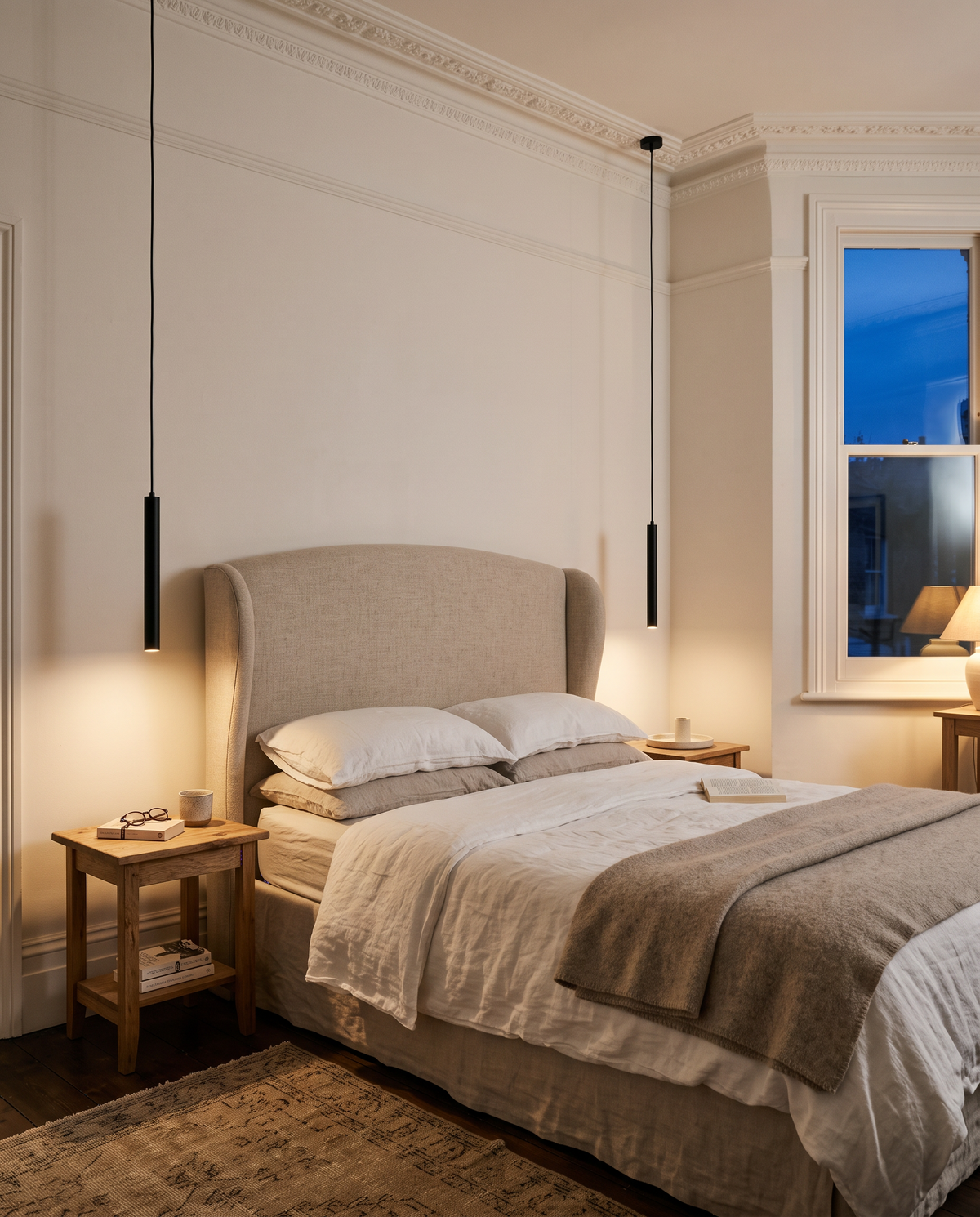 A pair of Plumb pendants hanging low either side of a bed in a Victorian terrace