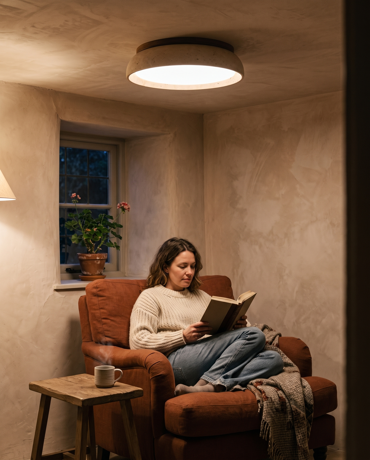 A woman reading in a Cotswold cottage snug under The Quarry