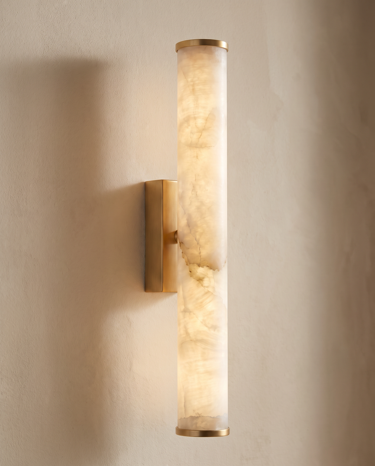 The stone baton of The Quill glowing, with light up and down the wall