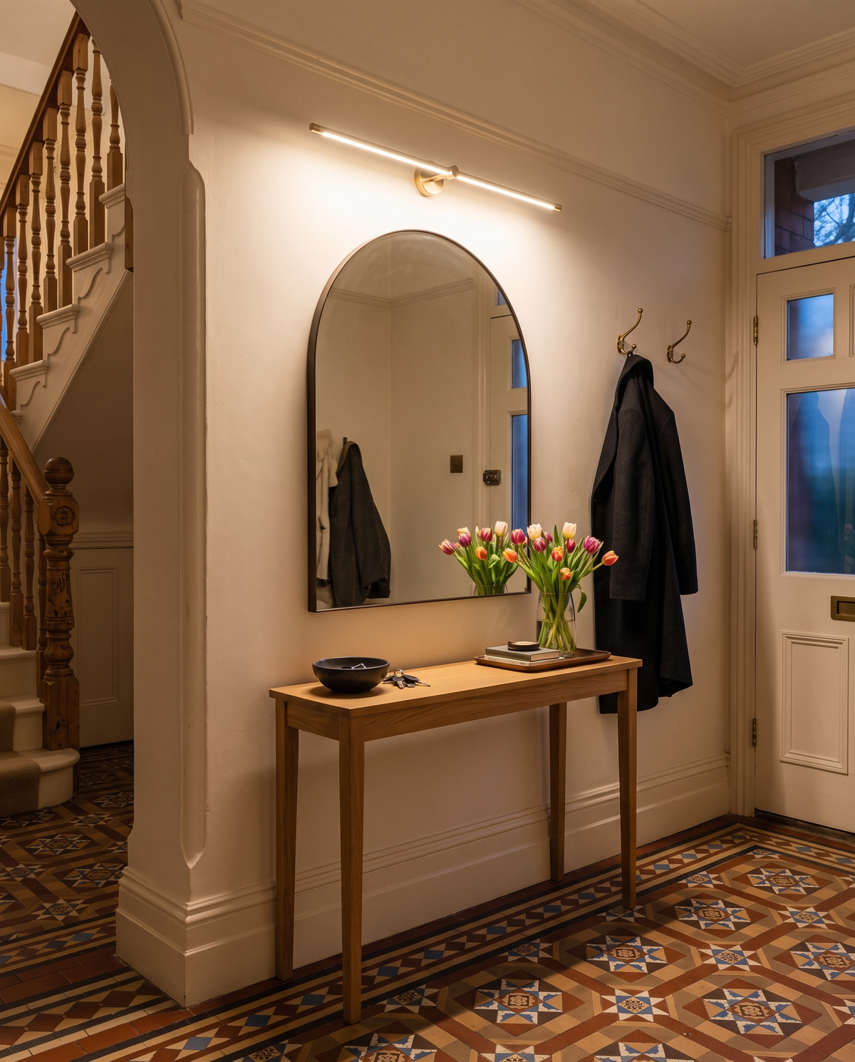 The Rail in Gold above a hall mirror