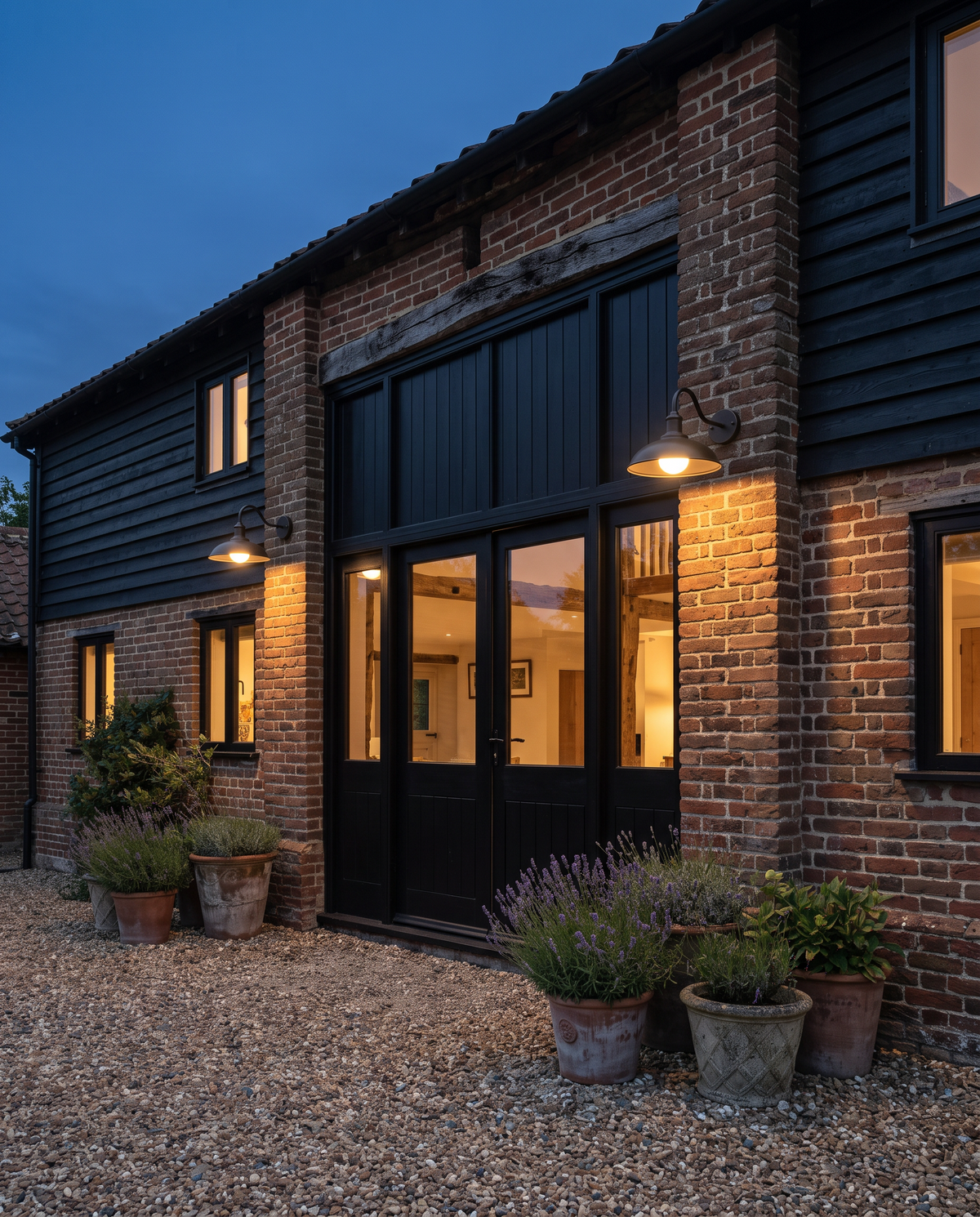 Two Stable lights with long arms over the doors of a converted barn
