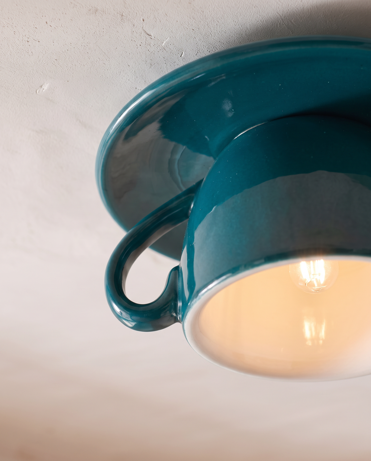 Close-up of the glossy Teal glaze and white interior of The Teacup