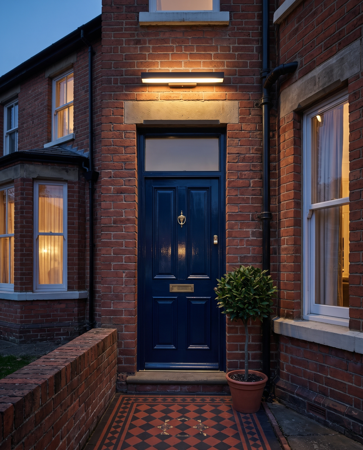 The Threshold beside the blue front door of a Victorian terrace at dusk