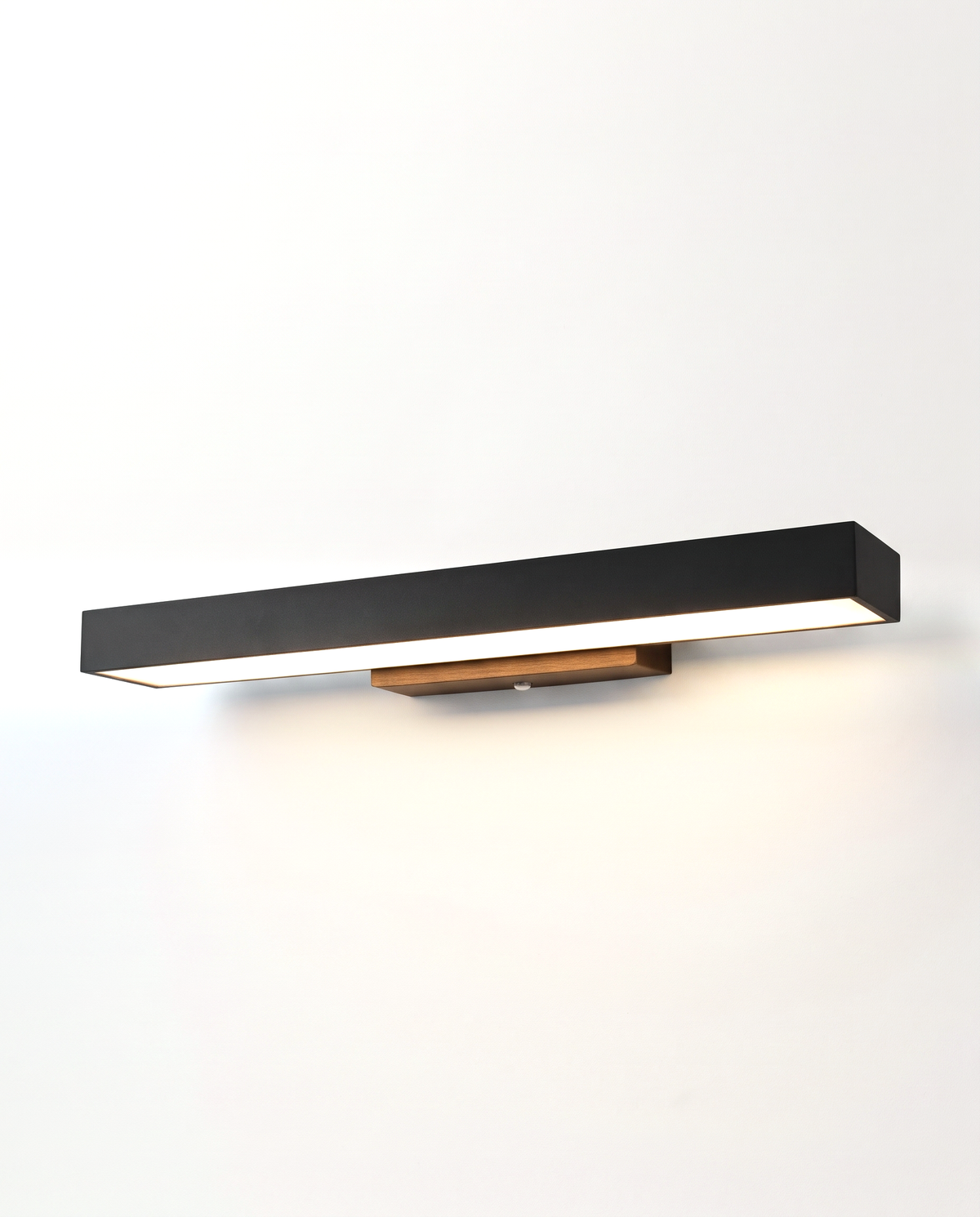 The Threshold Outdoor Wall Light, a slim black bar washing light down the wall