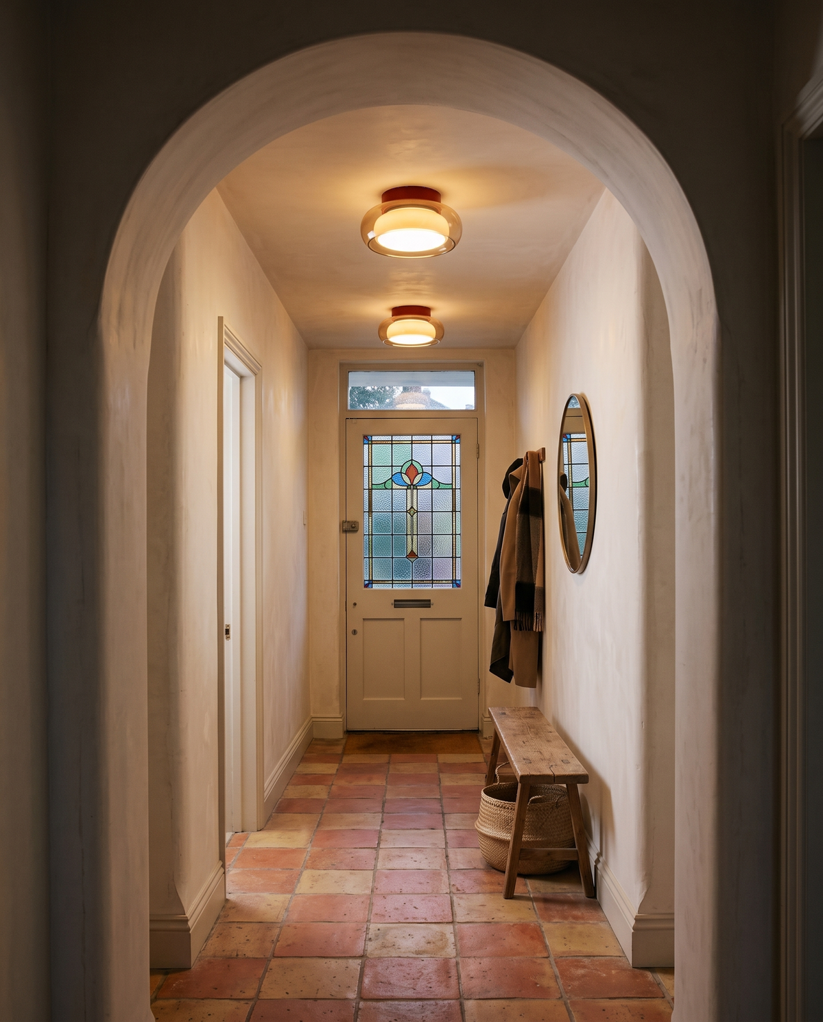 Two Toffee lights along an arched hallway