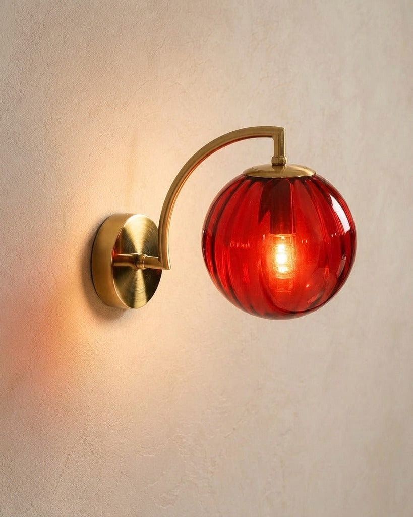 The Bloom, ribbed glass wall sconce, red glass on gold arm, mounted on plaster wall — Selden Home product photography
