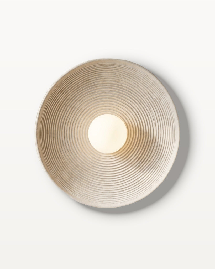 The Cocoon, rounded resin wall light casting a soft, enveloping glow — Selden Home product photography